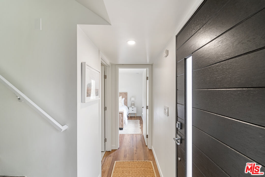 213 17th Street, Unit A Huntington Beach, CA 92648 - Photo 16 of 31 a view of a hallway with wooden floor and a bathroom
