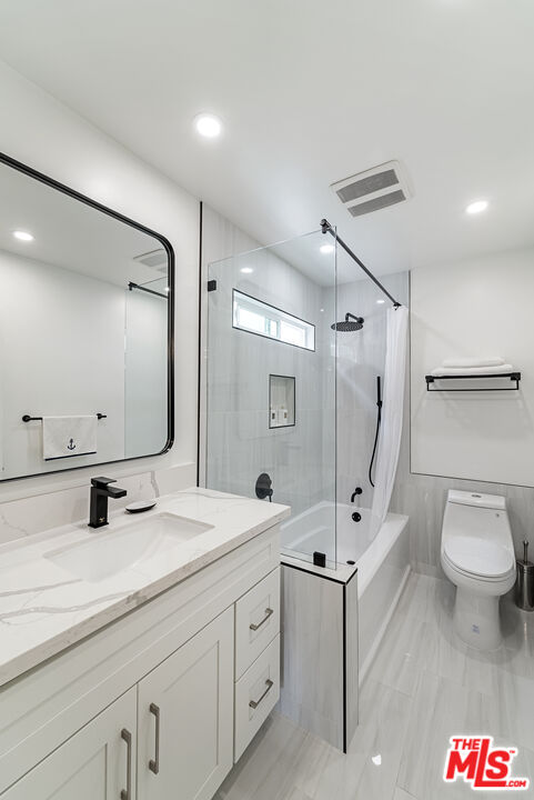 213 17th Street, Unit A Huntington Beach, CA 92648 - Photo 20 of 31 a bathroom with a toilet sink and mirror