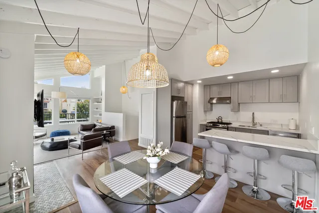 a view of a dining room and a table or chairs in wooden floor