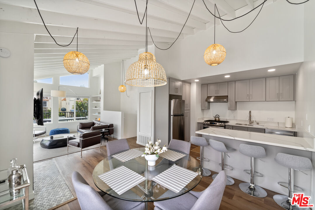 213 17th Street, Unit A Huntington Beach, CA 92648 - Photo 24 of 31 a view of a dining room and a table or chairs in wooden floor
