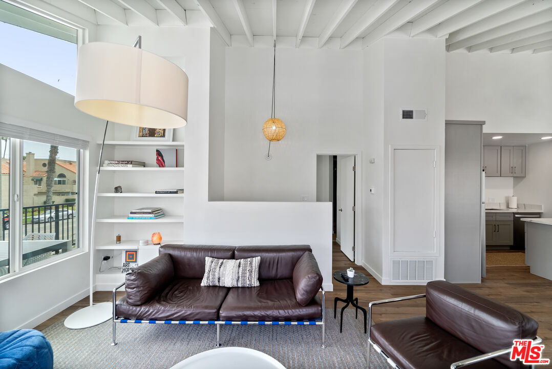 213 17th Street, Unit A Huntington Beach, CA 92648 - Photo 29 of 31 a living room with furniture and wooden floor
