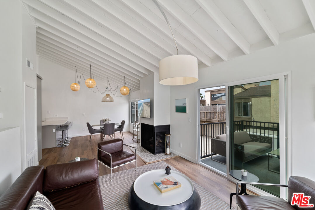 213 17th Street, Unit A Huntington Beach, CA 92648 - Photo 30 of 31 a living room with furniture and a wooden floor