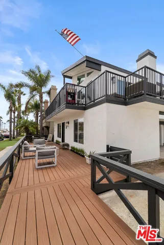 a view of a roof deck with wooden floor and city view