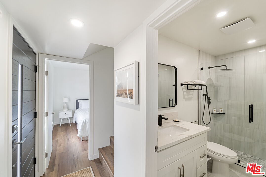 213 17th Street, Unit A Huntington Beach, CA 92648 - Photo 7 of 31 a en suite bathroom with a sink a toilet and shower