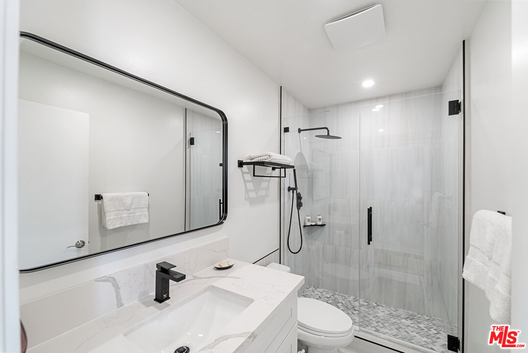 213 17th Street, Unit A Huntington Beach, CA 92648 - Photo 8 of 31 a bathroom with a sink toilet and shower