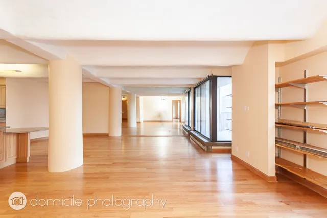 a view of an entryway with wooden floor