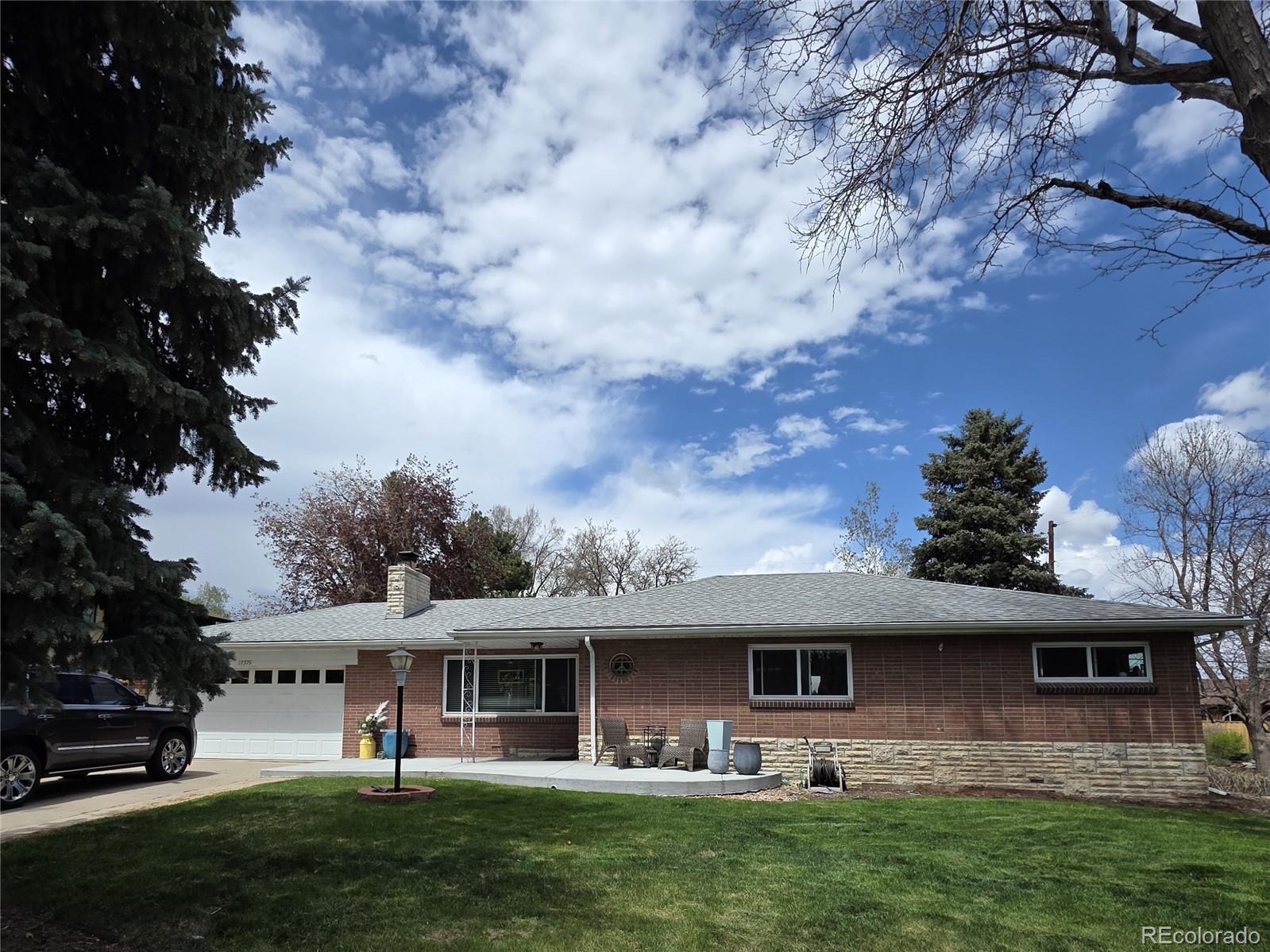 12375 West 19th Place Lakewood, CO 80215 - Photo 1 of 23 a view of a house with a garden