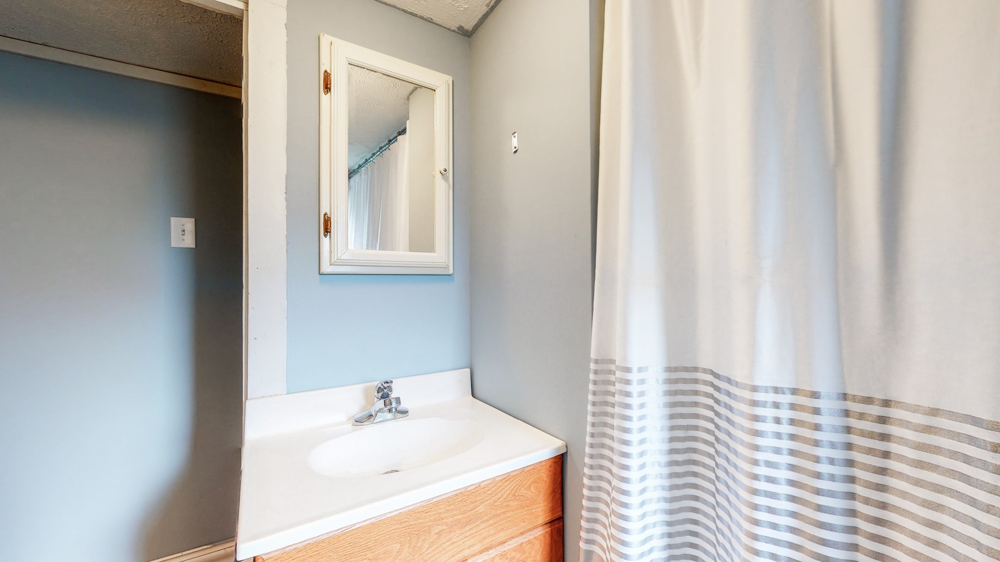 2977 Old Stewart Road Tennessee Ridge, TN 37178 - Photo 15 of 40 a bathroom with a sink and a mirror
