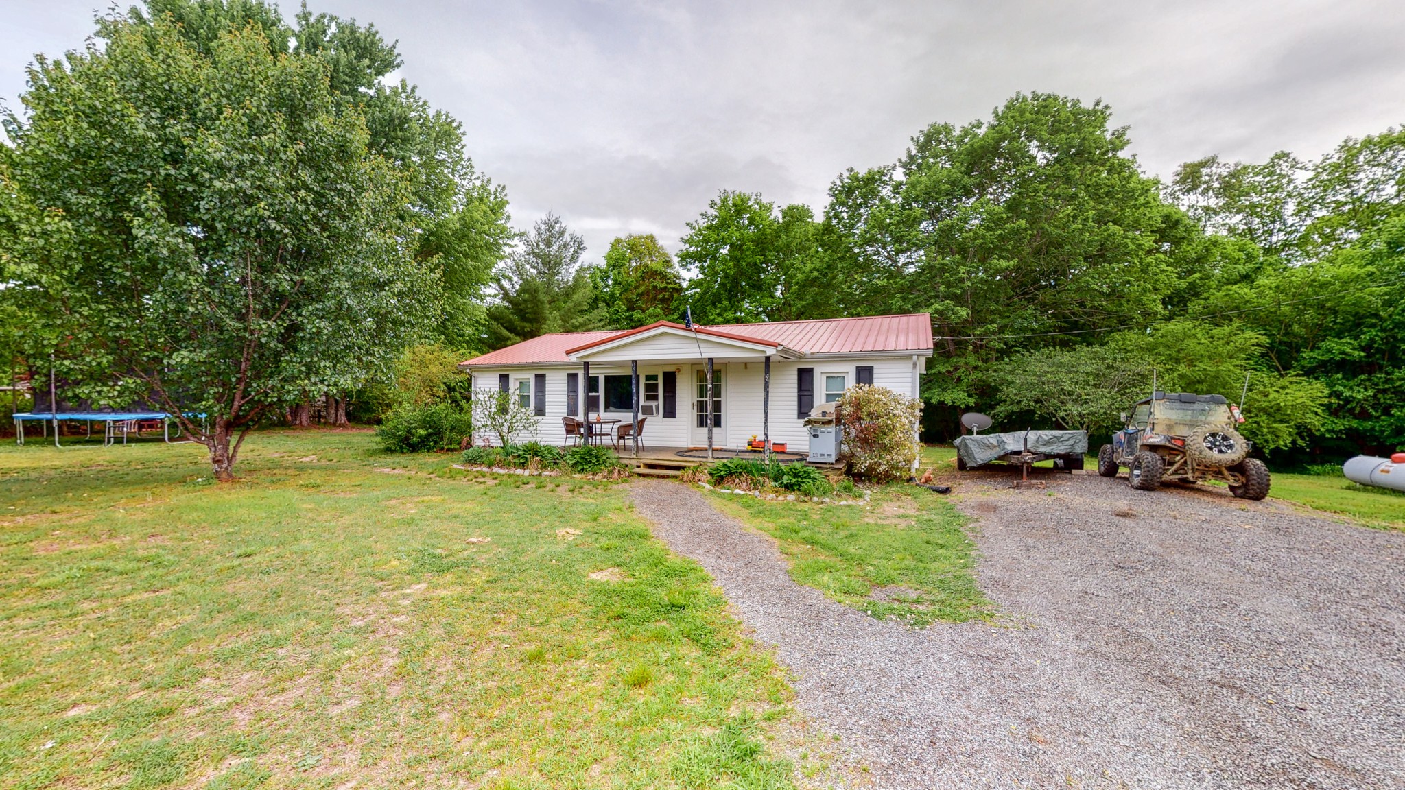 2977 Old Stewart Road Tennessee Ridge, TN 37178 - Photo 28 of 40 a front view of a house with a yard table and chairs