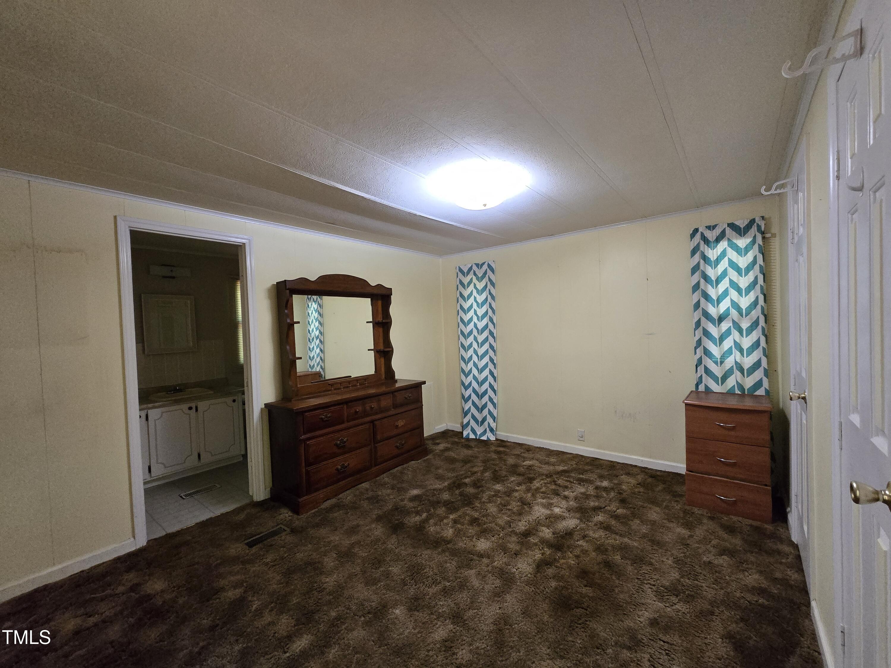 1337 Carroll Heights Road Zebulon, NC 27597 - Photo 6 of 9 a view of an empty room and window