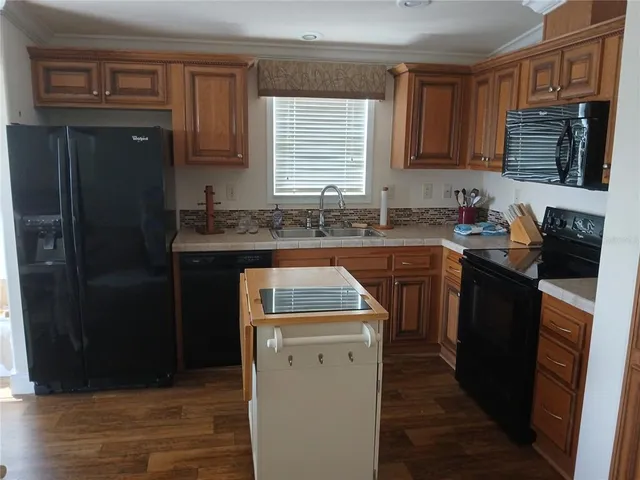 a kitchen with a sink stove and refrigerator