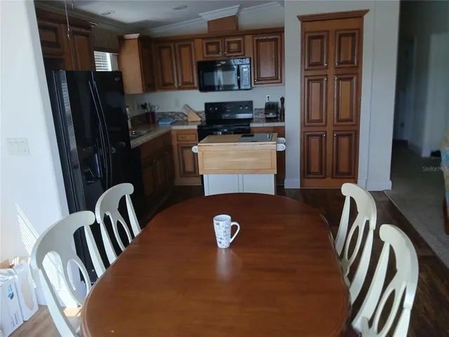 a kitchen with stainless steel appliances granite countertop a refrigerator stove top oven a sink and dishwasher