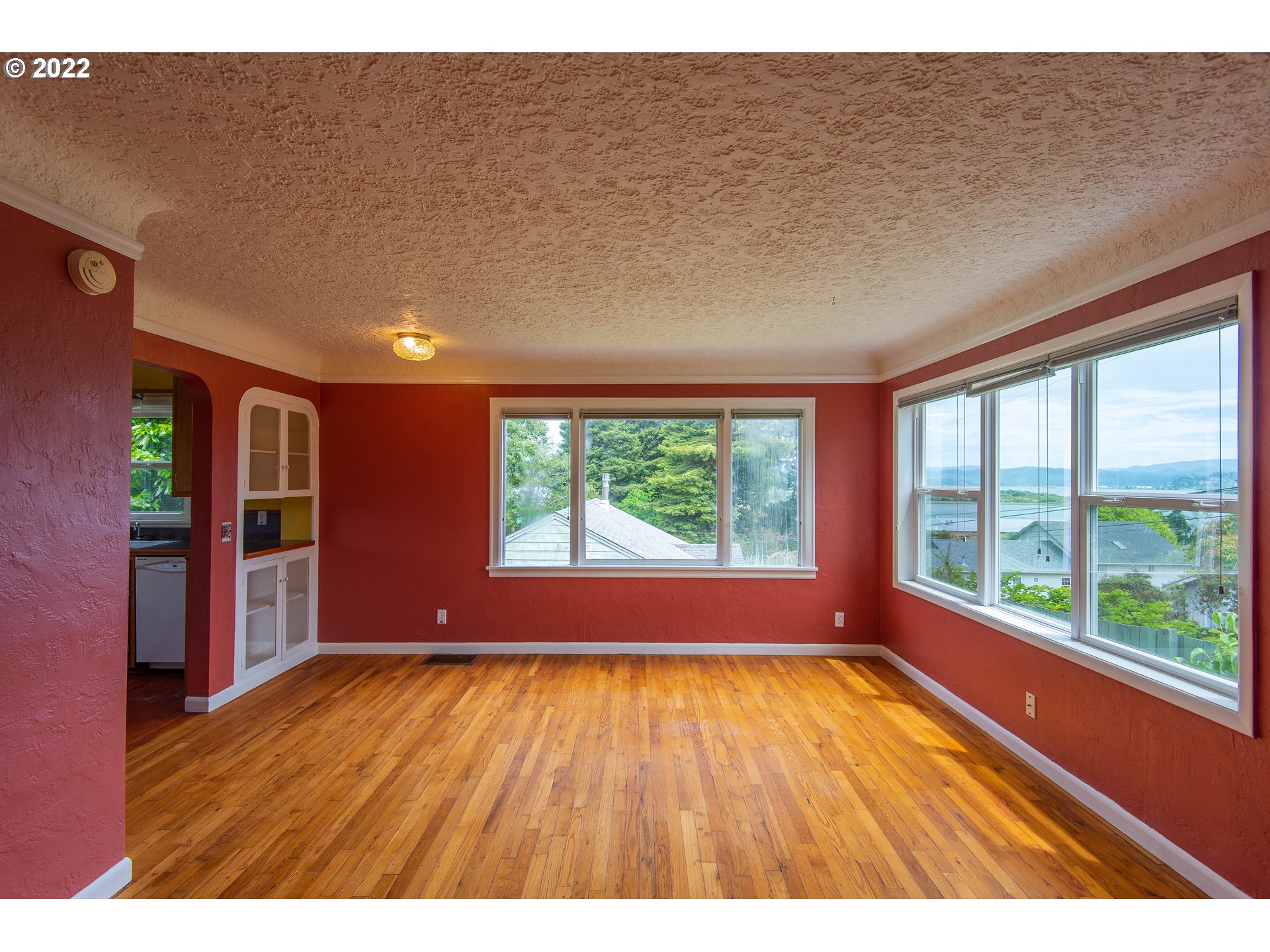 544 Clark Street North Bend, OR 97459 - Photo 6 of 32 a view of an empty room with wooden floor and a window
