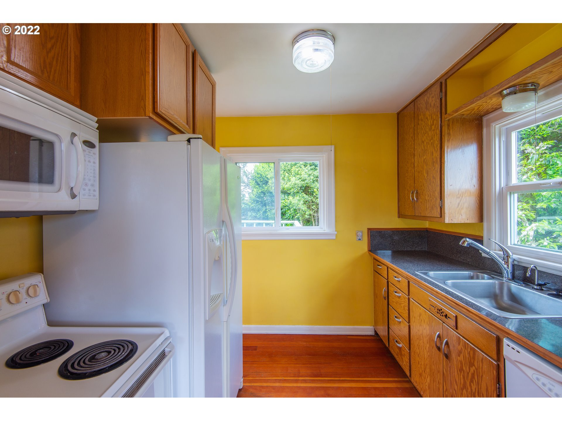 544 Clark Street North Bend, OR 97459 - Photo 9 of 32 a kitchen with stainless steel appliances a sink a stove and a refrigerator