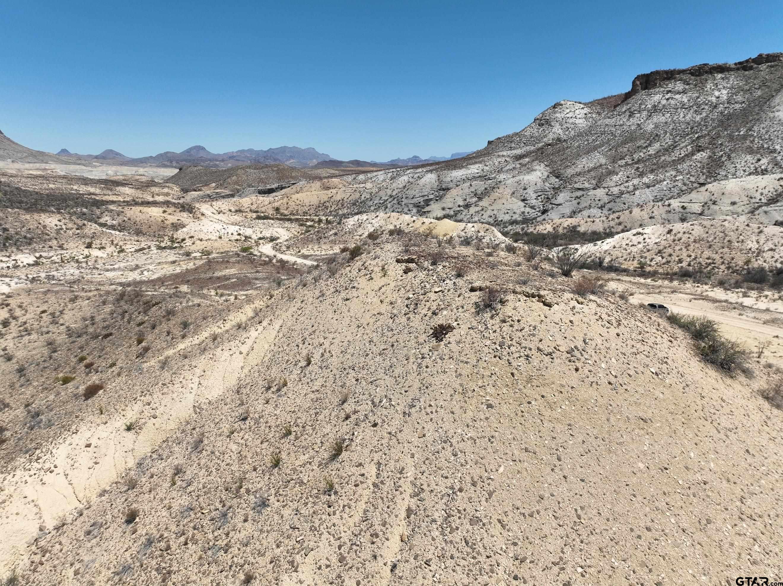 26549 Box Road Alpine, TX 79830 - Photo 10 of 18 a view of a dry yard with mountains in the background