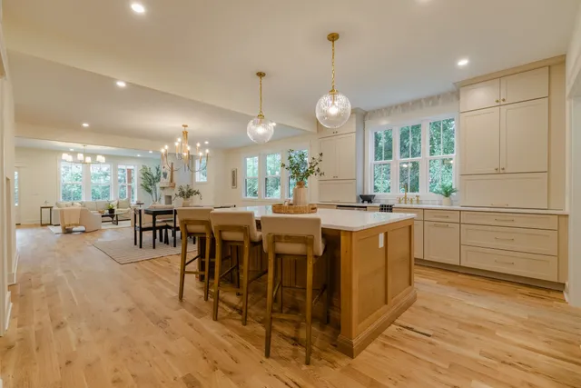 a large kitchen with lots of counter space and dining table
