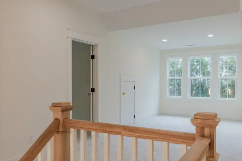 an empty room with a window and a ceiling fan
