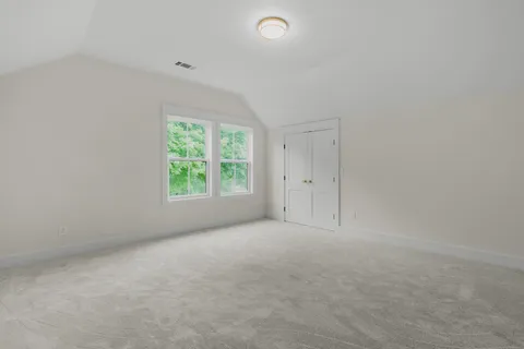 a view of a house with backyard and trees