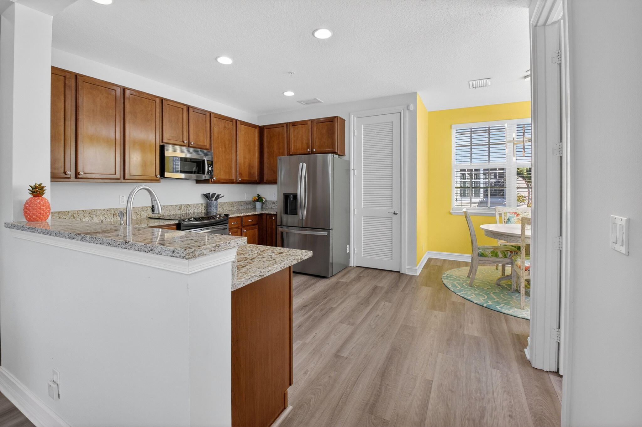 119 Southwest 2nd Avenue Delray Beach, FL 33444 - Photo 19 of 63 a kitchen with kitchen island granite countertop a sink cabinets and stainless steel appliances