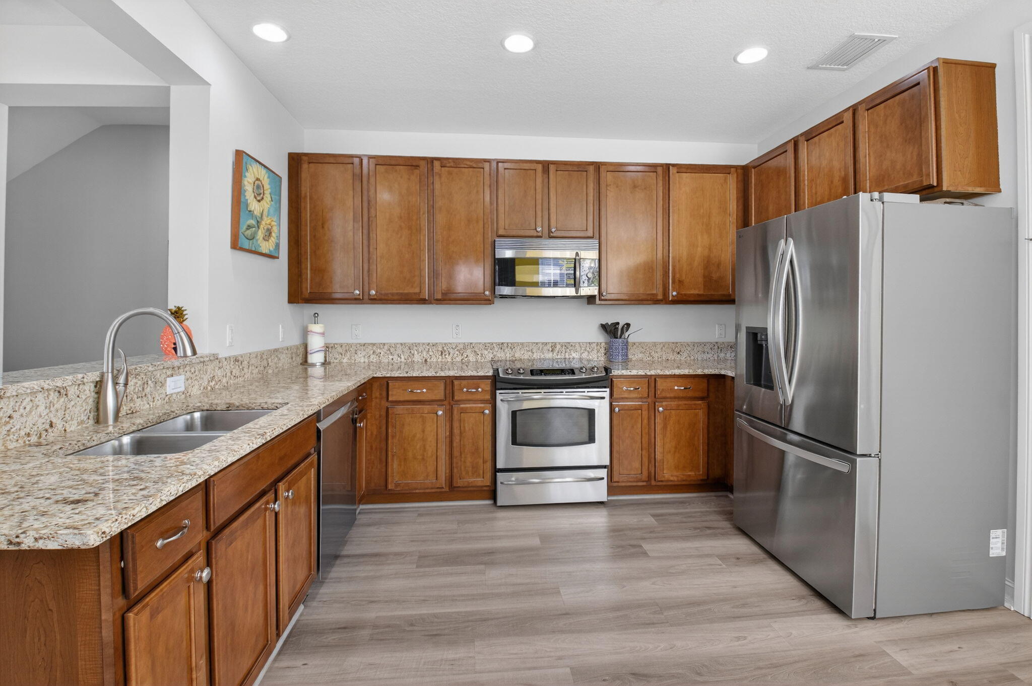 119 Southwest 2nd Avenue Delray Beach, FL 33444 - Photo 21 of 63 a kitchen with kitchen island granite countertop wooden cabinets stainless steel appliances and a sink