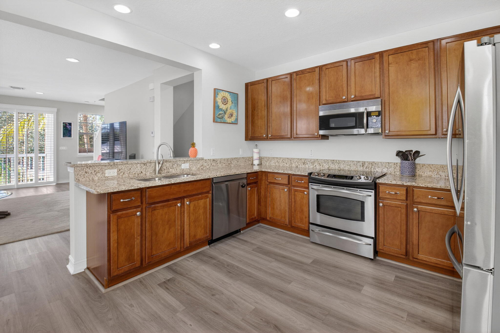 119 Southwest 2nd Avenue Delray Beach, FL 33444 - Photo 22 of 63 a kitchen with stainless steel appliances granite countertop a sink a stove top oven and wooden floors