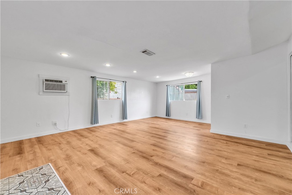 8682 La Grande Street Rancho Cucamonga, CA 91701 - Photo 14 of 29 a view of an empty room with wooden floor and a window