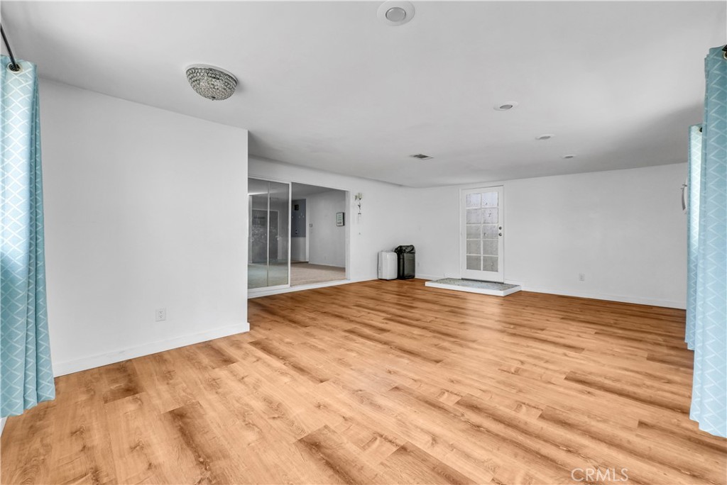 8682 La Grande Street Rancho Cucamonga, CA 91701 - Photo 15 of 29 a view of empty room with wooden floor and fan