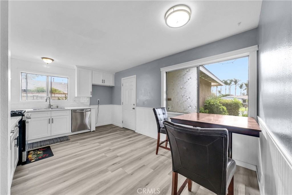 8682 La Grande Street Rancho Cucamonga, CA 91701 - Photo 7 of 29 a kitchen with a table chairs a sink dishwasher window and cabinets