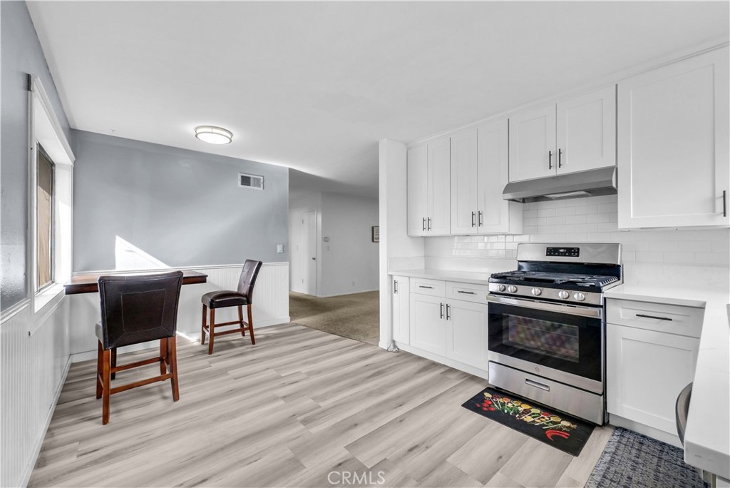 8682 La Grande Street Rancho Cucamonga, CA 91701 - Photo 9 of 29 a kitchen with granite countertop a stove a sink and a refrigerator