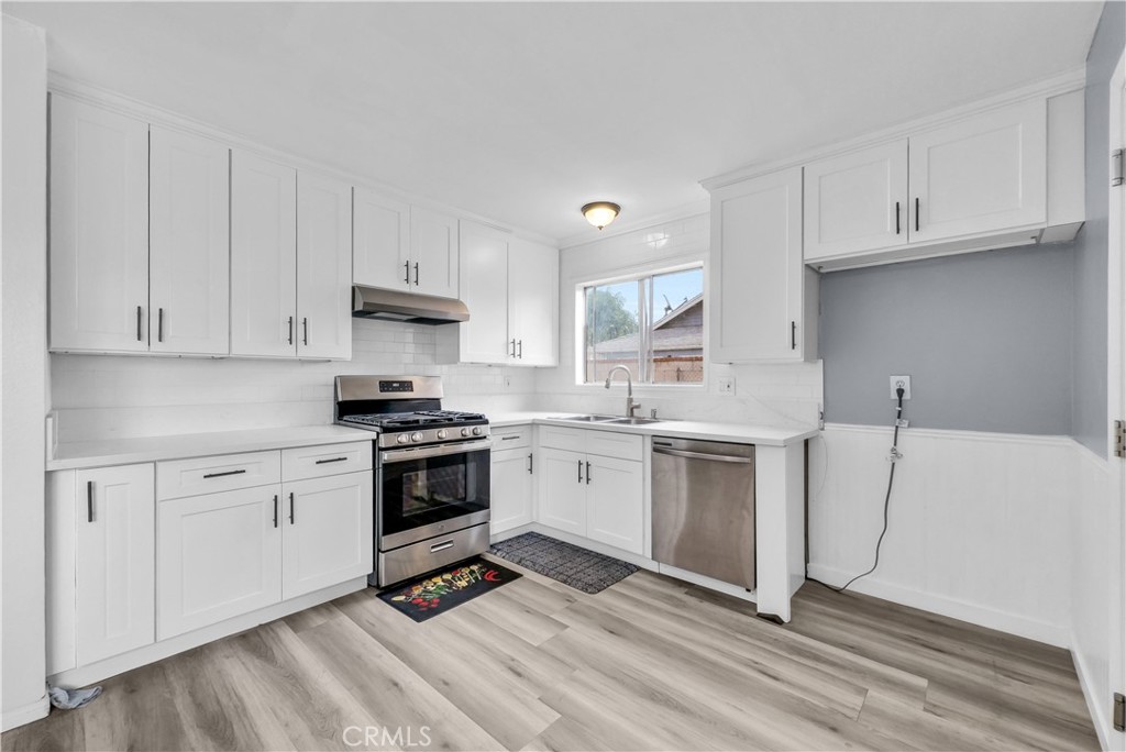 8682 La Grande Street Rancho Cucamonga, CA 91701 - Photo 10 of 29 a kitchen with white cabinets and appliances
