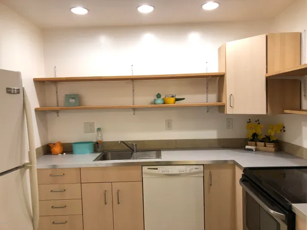 a kitchen with a sink a stove and cabinets