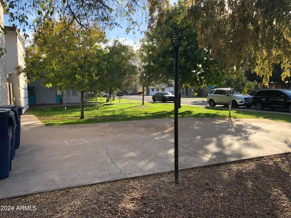 a view of a street with cars parked