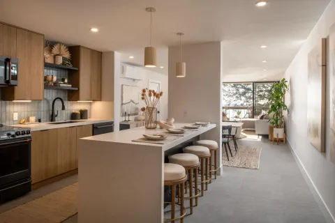 a kitchen with counter space dining table and chairs