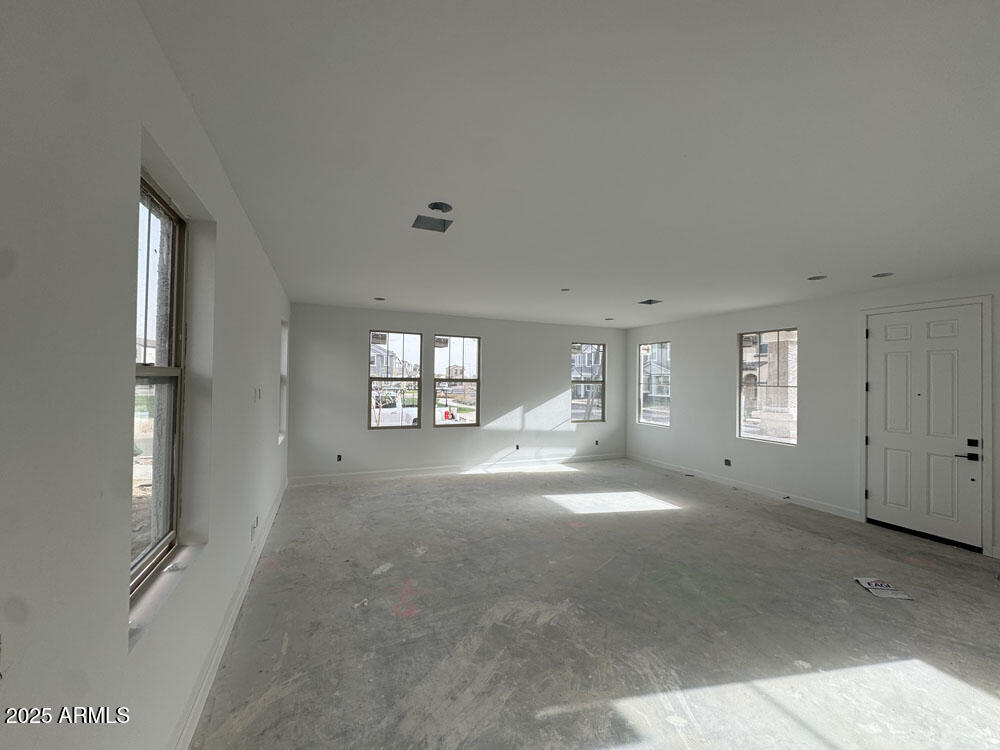2232 West Chisum Trail Phoenix, AZ 85085 - Photo 7 of 75 a view of a big room with windows and chandelier fan