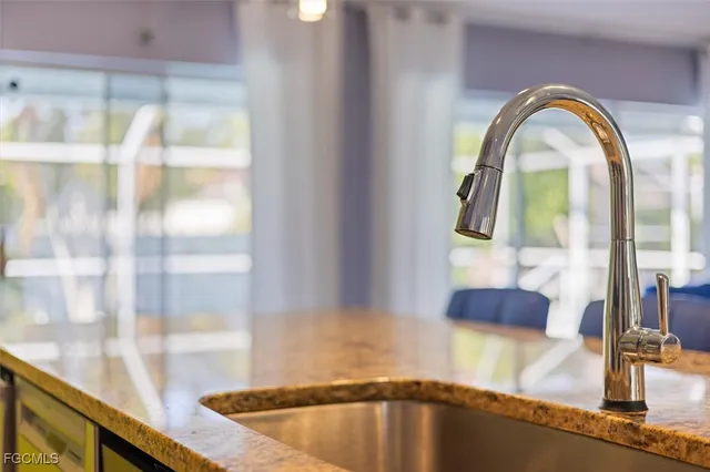 a kitchen with granite countertop a sink and cabinets