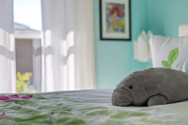 a bedroom with a bed and a chandelier