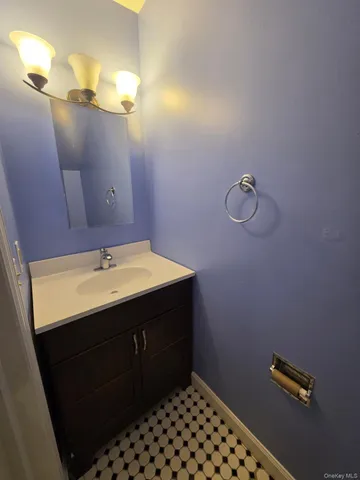 a bathroom with a sink vanity and a mirror