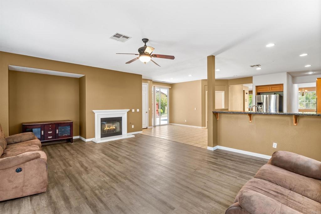 1049 Boulder Place Oceanside, CA 92057 - Photo 11 of 49 a view of a livingroom with wooden floor and a fireplace