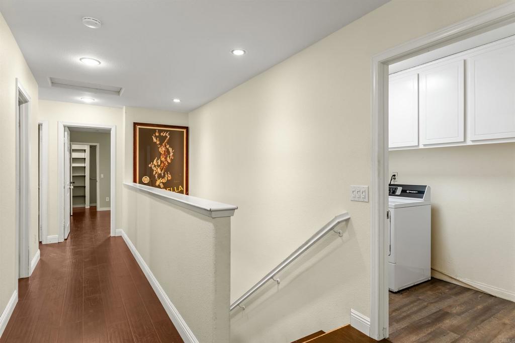 1049 Boulder Place Oceanside, CA 92057 - Photo 15 of 49 a view of a hallway with wooden floor and staircase