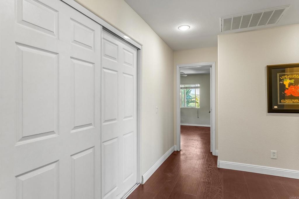 1049 Boulder Place Oceanside, CA 92057 - Photo 16 of 49 an empty room with wooden floor closet and windows