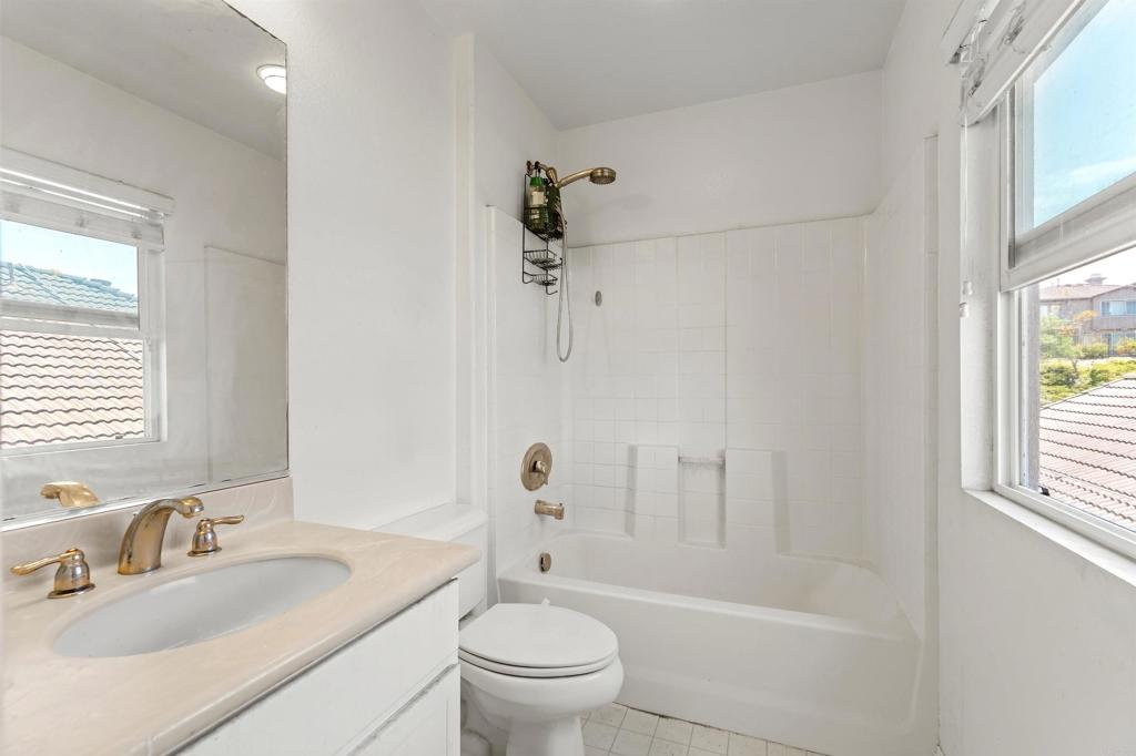 1049 Boulder Place Oceanside, CA 92057 - Photo 19 of 49 a bathroom with a sink a toilet and a large mirror