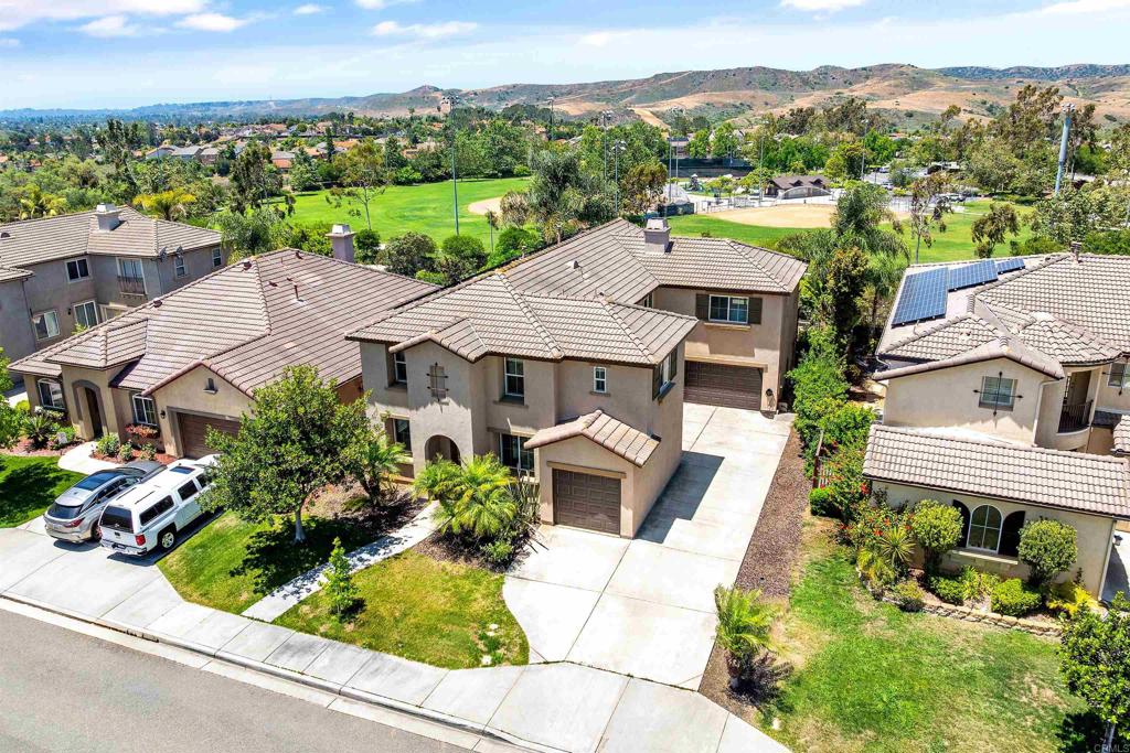 1049 Boulder Place Oceanside, CA 92057 - Photo 2 of 49 an aerial view of multiple houses with a yard