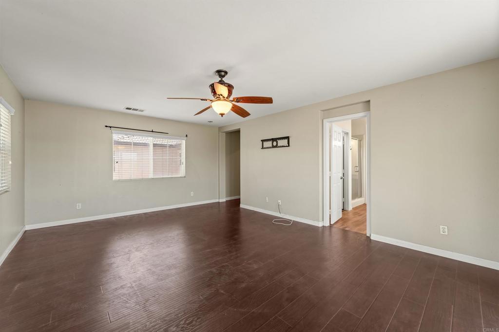 1049 Boulder Place Oceanside, CA 92057 - Photo 21 of 49 a view of an empty room with a window and wooden floor