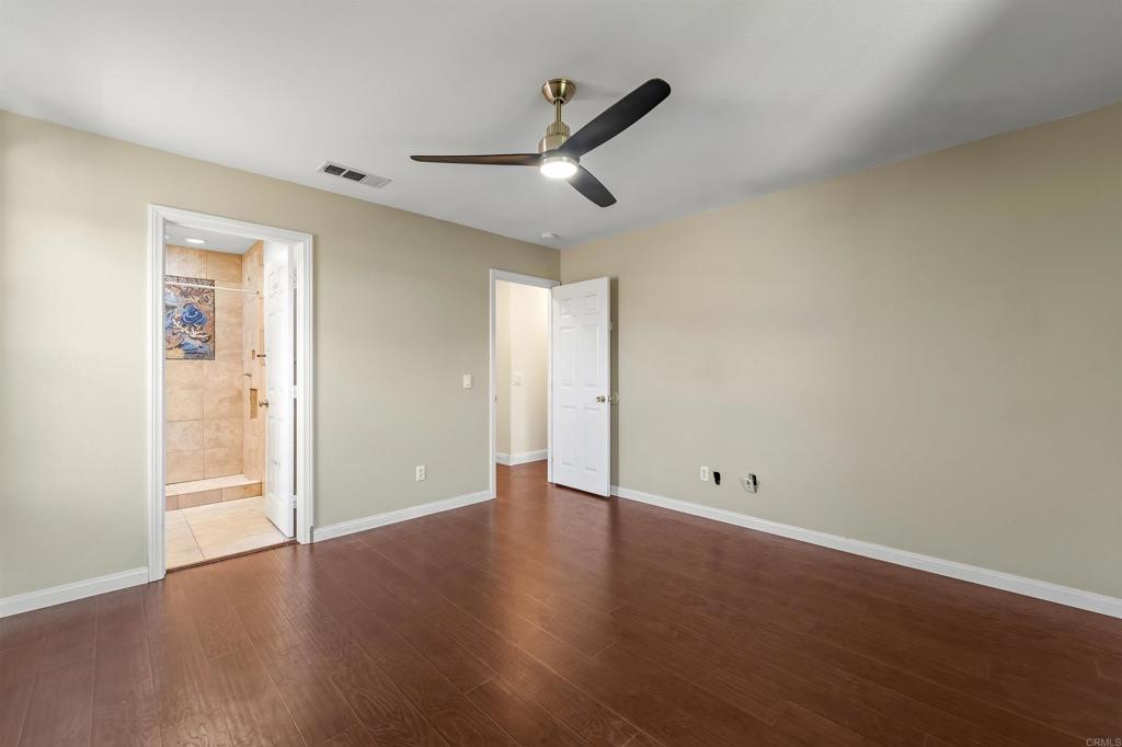 1049 Boulder Place Oceanside, CA 92057 - Photo 27 of 49 a view of an empty room with wooden floor