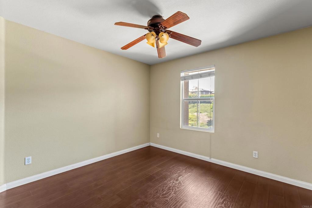 1049 Boulder Place Oceanside, CA 92057 - Photo 31 of 49 an empty room with window and chandelier fan