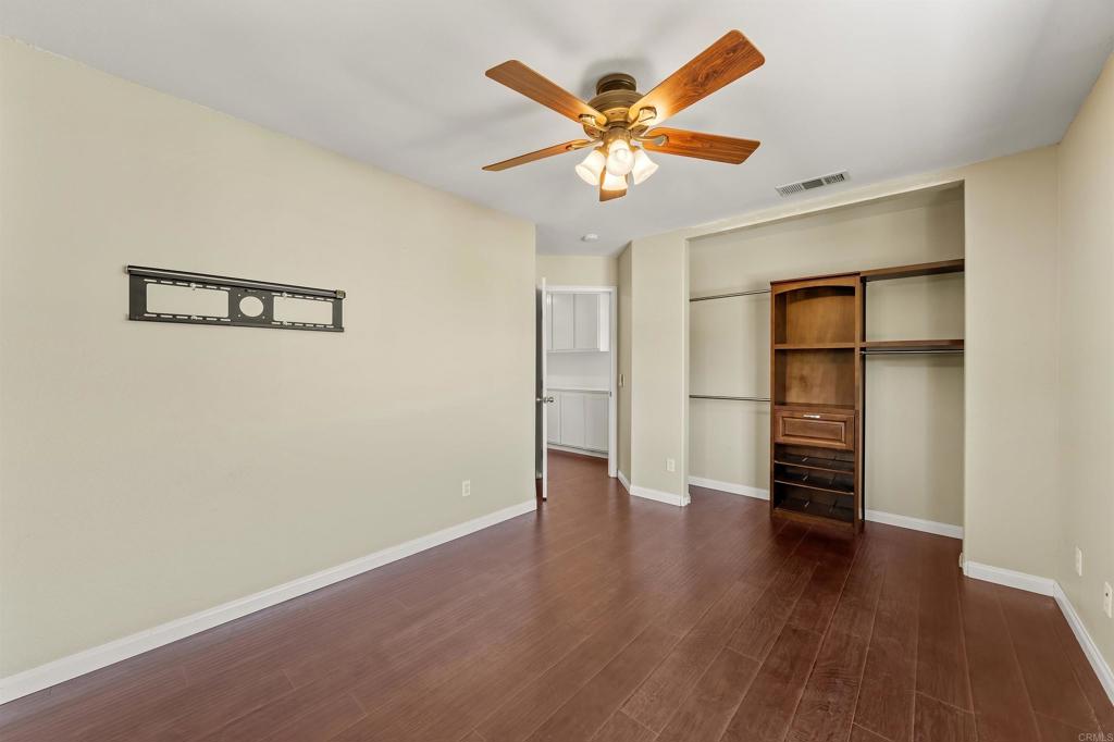 1049 Boulder Place Oceanside, CA 92057 - Photo 34 of 49 an empty room with wooden floor and closet