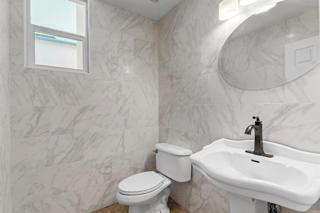 1049 Boulder Place Oceanside, CA 92057 - Photo 43 of 49 a white toilet sitting next to a bathroom sink