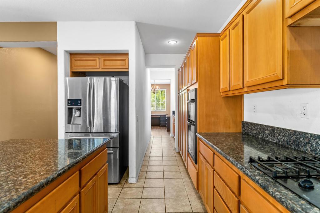 1049 Boulder Place Oceanside, CA 92057 - Photo 8 of 49 a kitchen with stainless steel appliances granite countertop a refrigerator and a stove