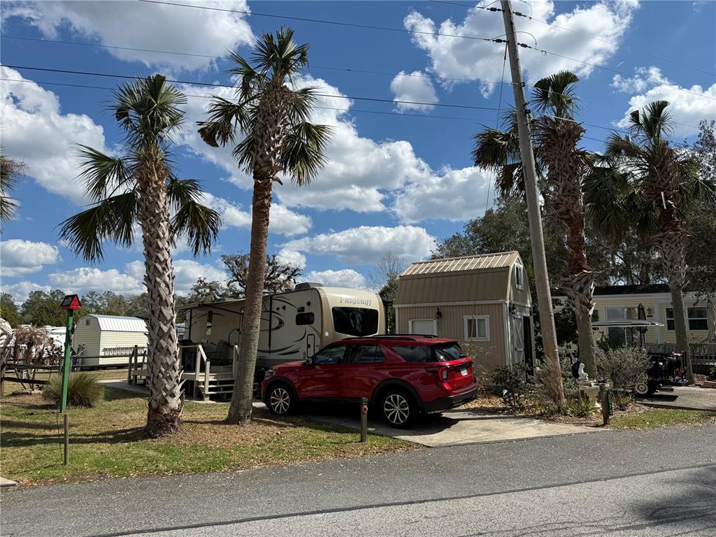 2875 Northeast 102nd Ave Road Silver Springs, FL 34488 - Photo 2 of 68 a view of a cars park in front of a building