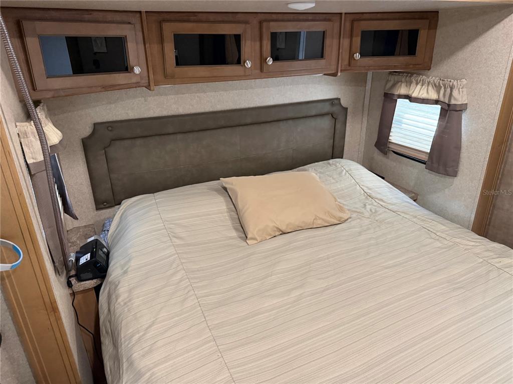 2875 Northeast 102nd Ave Road Silver Springs, FL 34488 - Photo 23 of 68 a bedroom with a bed and a television